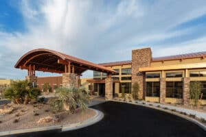 Front entrance to Canyon Vista Post Acute with Palm trees and blue skies