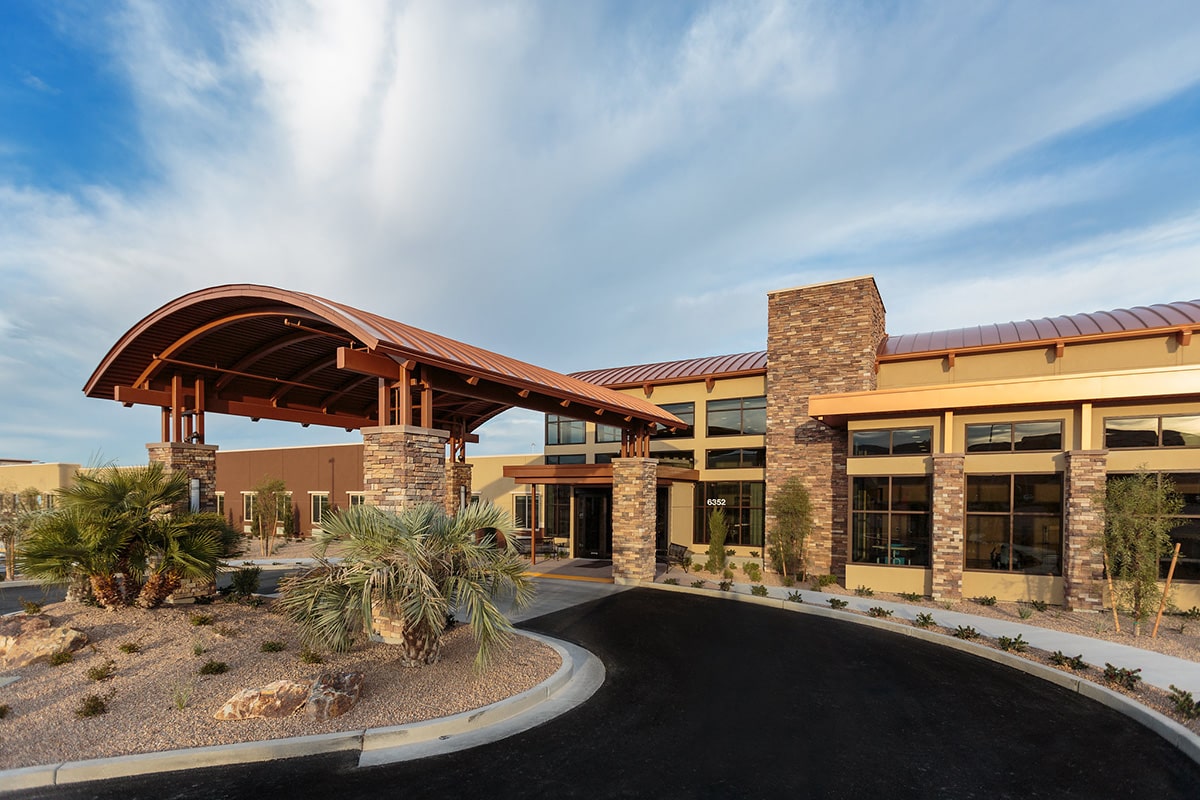 Front entrance to Canyon Vista Post Acute with Palm trees and blue skies
