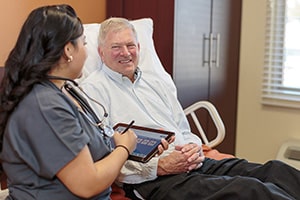 A nurse taking care of an elderly man at Canyon Vista Post Acute