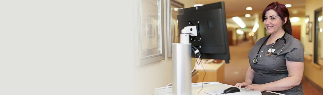 Nurse looking at a computer at Canyon Vista